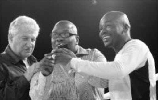 WITH THIS RING...: Rodney Berman of Golden Gloves and trainer Eugene congratulate Thomas Mashaba after he was presented with an IBO ring. Pic. Antonio Muchave. 03/02/08. © Sowetan.