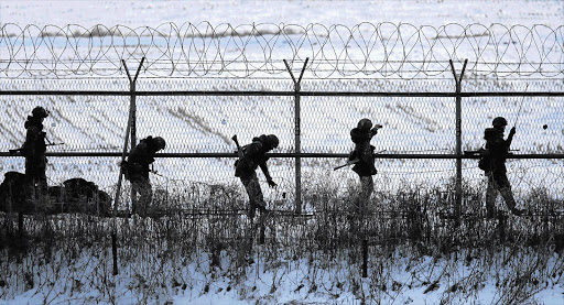 South Korean soldiers check military fences as they patrol near the demilitarised zone separating North Korea from South Korea, in Paju, north of Seoul, yesterday. North Korea conducted its third nuclear test yesterday in defiance of UN resolutions, angering the US Picture: LEE JAE-WON/REUTERS
