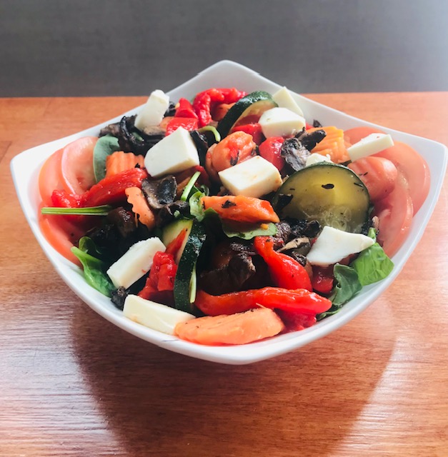 Veggie Bowl: roasted seasonal vegetables over a bed of greens. Choice of toppings and dressing.