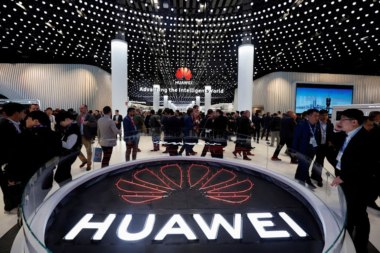 People visit the Huawei stand at the 2024 Mobile World Congress in Barcelona, Spain, on February 27, 2024. Intel is hanging on to a licence to sell chips to Chinese company Huawei, while rival AMD has been unable to obtain similar permission from the US commerce department. REUTERS/ALBERT GEA/FILE