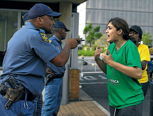 October 15, 2015. STRONG: Shaeera Kalla argues with a police officer as thousands of Wits students gathered in Johannesburg this week.