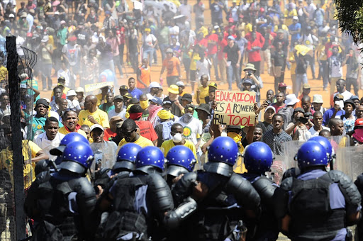 University students march on the Union Buildings on October 23 as part of a nationwide protest against a tuition fee increase and to demand that tertiary education be free. Police fired rubber bullets to disperse the crowd