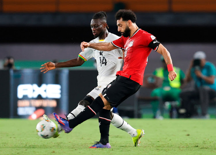 Egypt's Mohamed Salah (wearing red) in action with Ghana's Gideon Mensah.