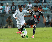 Thembela Sikhakhane of AmaZulu and Relebohile Ratomo of
Orlando Pirates during their DStv Premiership match at
Orlando Stadium on Saturday.