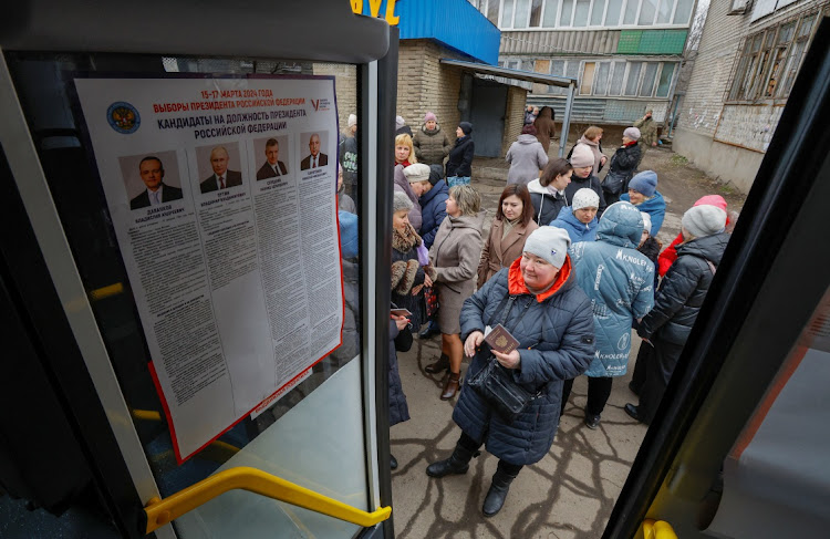 Voters gather outside a mobile polling station located in a bus, on the final day of Russia's presidential election in the course of Russia-Ukraine conflict in Makiivka (Makeyevka) in the Donetsk region, Russian-controlled Ukraine on March 17 2024. Picture: REUTERS/Alexander Ermochenko