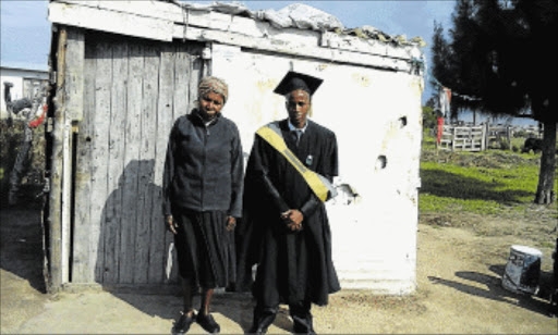 ON THE ROAD TO SUCCESS: University of Pretoria graduate, Anele George and his proud mother, Nobendiba George, standing in front of their one-room shack in Phola Park in Dimbaza Picture: FACEBOOK