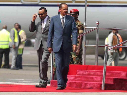 Eritrea's President Isaias Afwerki is welcomed by Ethiopian Prime Minister Abiy Ahmed upon arriving for a three-day visit, at the Bole international airport in Addis Ababa, Ethiopia July 14, 2018. /REUTERS