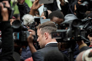 Paralympian Oscar Pistorius leaves the high court in Pretoria, on June 14, 2016 on the second day of his pre-sentencing hearing.