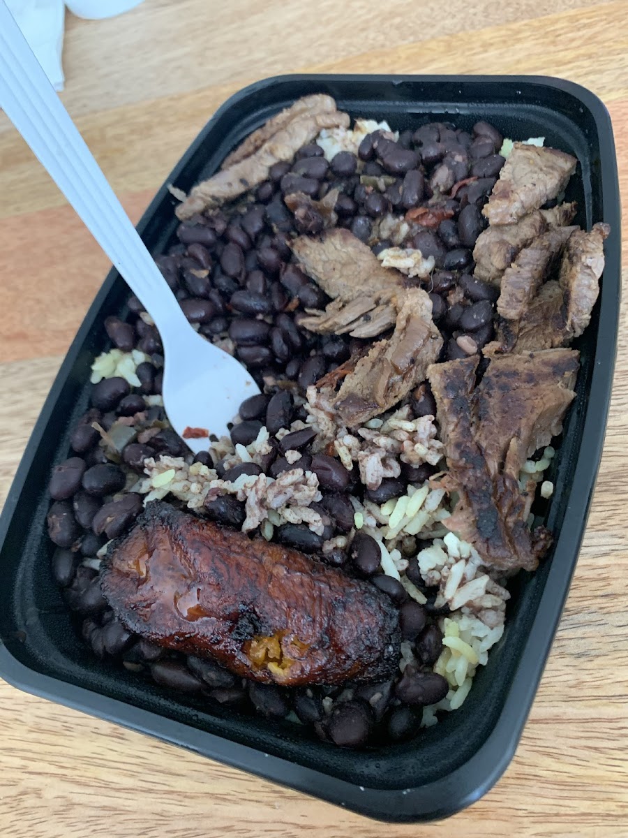 Steak over rice and beans with maduros (sweet plantain)