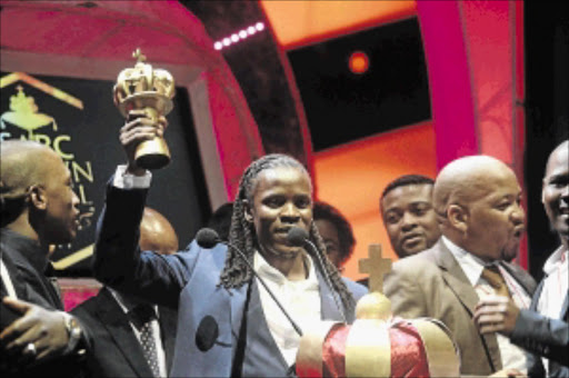 controversy: Singer Betusile Mcinga lifts one of his trophies on Sunday night at the Crown Gospel Music Awards Photos: Veli Nhlapo