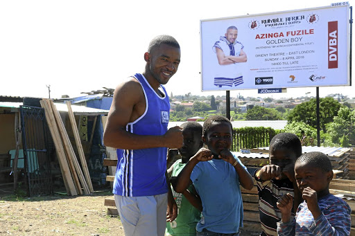 Azinga Fuzile poses near a billboard with his image in Duncan Village, East London, in the Eastern Cape.