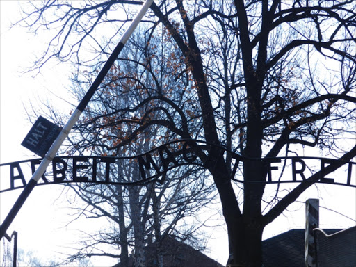 The sign over the entrance to Auschwitz camp in Poland. The English translation is “Works makes you free".