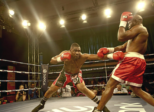 Akani Phuzi throws a punch at Mussa Ajibu from Malawi during their international cruiserweight fight at Blairgowrie Recreation Centre. /Masi Losi
