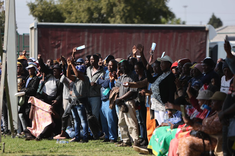 Residents of Hammanskraal listen to an address by President Cyril Ramaphosa during a community meeting as part of the government's response to a cholera outbreak in the area.