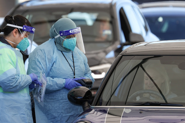 Medical workers administer tests at the Bondi Beach drive-through coronavirus disease (Covid-19) testing centre in the wake of new positive cases in Sydney, Australia, June 17, 2021.