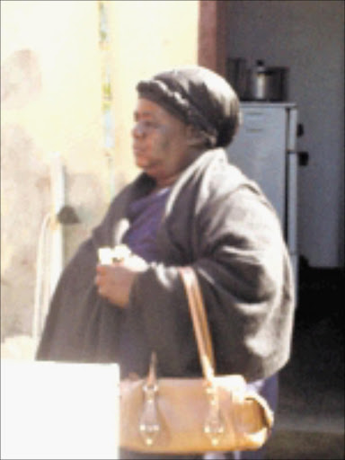 U-TURN: Bapakiyeng Mohlala, 'mistress ' of the late Piet Sebopela, leaves the house she and his widow have been fighting over. Circa 2009. Pic. Unknown.