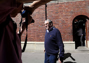 A Dutch fugitive, convicted of crimes against humanity and selling firearms to former Liberian president Charles Taylor, Augustinus Petrus Kouwenhoven leaves Cape Town Magistrate Court after paying his bail of one million rand.