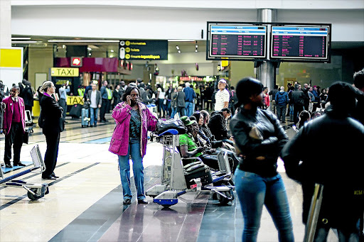 TAKE IT OFF, TAKE IT OFF... A scene at OR Tambo International Airport in Johannesburg with people about to board planes. Going through airport securiy checkpoints these days is like participating in a strip show, says the writer photo: danielborn