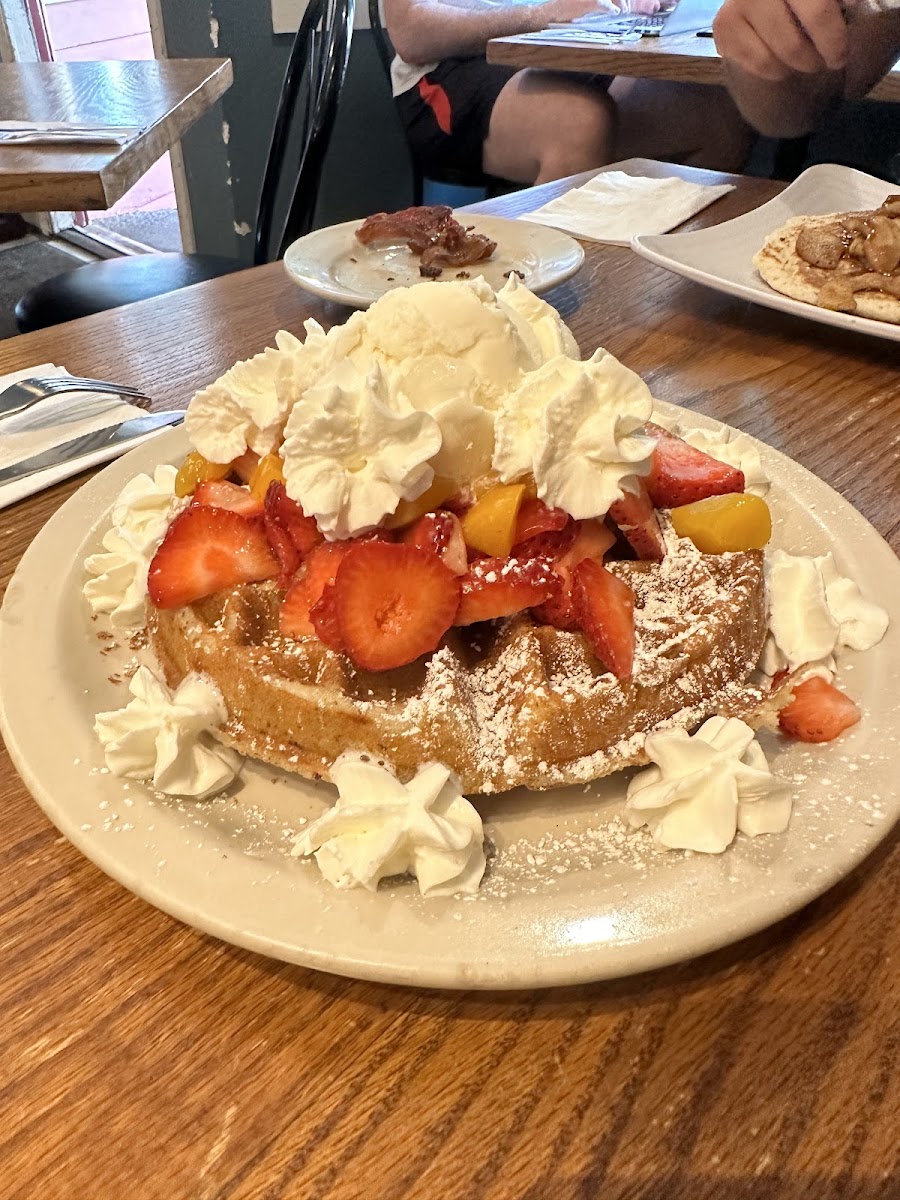 Gf waffle with strawberries, peaches, and ice cream
