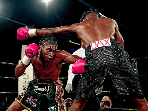 Thulani Mbenge, seen here taking on Eric Kapia Mukadi in a recent fight, stands a big chance to contest the Welterwight Super Four later this year. PHOTO: ANTON GEYSER/GALLO IMAGES