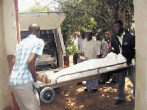 TRAGIC: Officials remove the bodies of ward 12 councillor Mathews Manthata and his lover Olivia Machaka from the shooting scene. Manthata shot and killed Machaka and then turned the gun on himself after an argument yesterday.Pic.CHESTER MAKANA. 02/02/2010. © Sowetan. PATH OF DEATH:Forensic pathologist officials remove the corpse of Molemole municipal workers, after councilor kil girlfriend then himself. PHOTO:CHESTER MAKANA