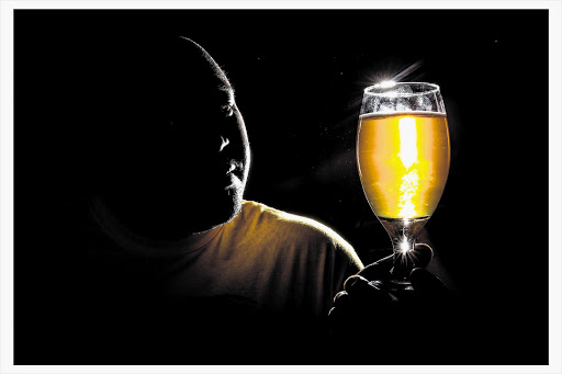 ALE FOR SALE: Micro brewer Ndumiso Madlala holds a glass of his Soweto Gold beer at a local restaurant