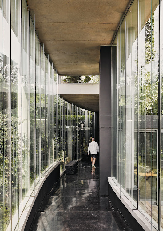 A glass spine connects the various areas of the house, designed by landscaper Patrick Watson to create the feeling of a village of rooms.