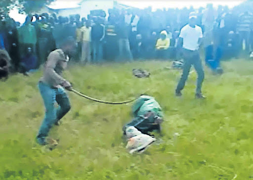 CONDEMNED: This screen grab shows David Tsali, bound and lying on the ground, being beaten to death by an angry mob