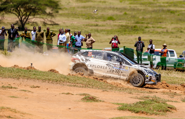 Fans watch a rally car at the WRC Safari Rally shakedown in Naivasha on March 27, 2024.