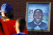 A portrait of Ahmaud Arbery, an unarmed young Black man shot and killed after being chased by a white former law enforcement officer and his son, is pictured during a candle light vigil to mark the one year anniversary of his death, at New Springfield Baptist Church in Waynesboro, Georgia, US February 23, 2021. 