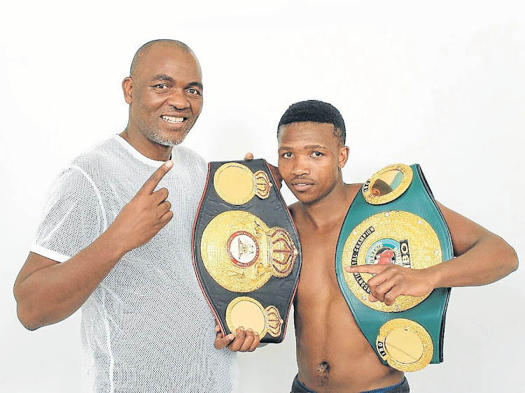 Mzuvukile Magwaca, seen here with his former manager Mla Tengimfene, will start afresh this evening when he vies for the WBF bantamweight title after getting stripped of his previous belts.