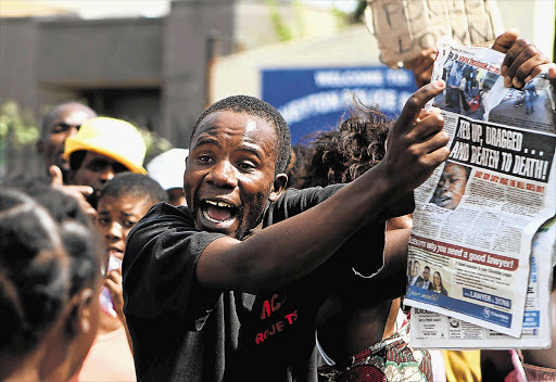 Angry protesters outside the Daveyton police station after a taxi driver from Mozambique was dragged by a police van and then beaten to death while in custody at the station