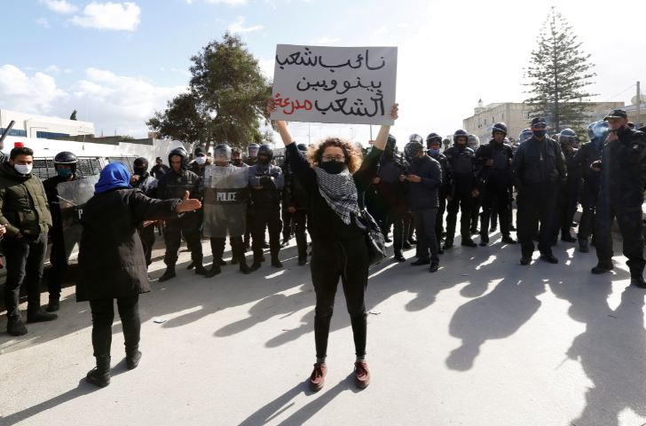A demonstrator holds up a sign during an anti-government protest in Tunis, Tunisia on January 26 2021.