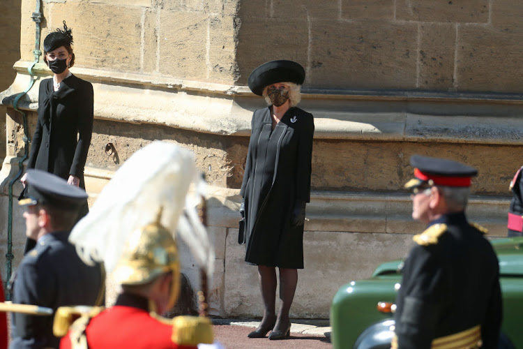 Prince William's wife, Catherine, Duchess of Cambridge (left), and her mother-in-law, Camilla, Duchess of Cornwall, watch the funeral procession of Prince Philip, Duke of Edinburgh.