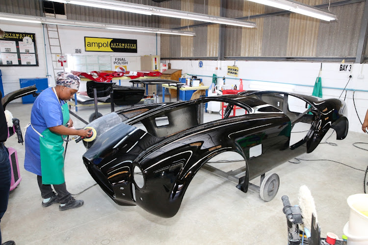 Lucia Tiervlei polishes a Shelby Cobra 'continuation' car at the Hi-Tech Automotive factory in Greenbushes.