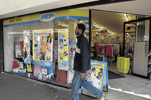 A man walks past a Pepkor store