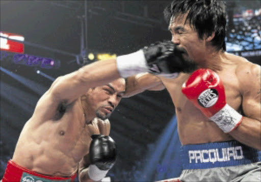 WIDE OPEN: Mexico's Juan Manuel Marquez delivers a right to Manny Pacquiao's jaw in Las Vegas, Nevada, on Saturday night. PHOTO: REUTERS