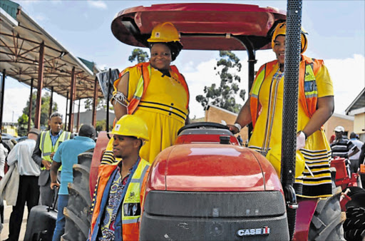 BRAND NEW: Chris Hani mayor Kholiswa Vimbayo and Engcobo mayor Lizeka Tyali test a new tractor at a handover Picture: SUPPLIED