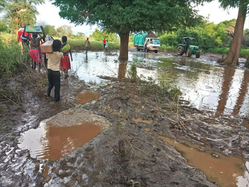 Residents flee at Nangolerengan village in Tirioko ward in Tiaty Sub-county, Baringo County after Kerio River burst its banks, killing one and causing floods on Sunday. /JOSEPH KANGOGO