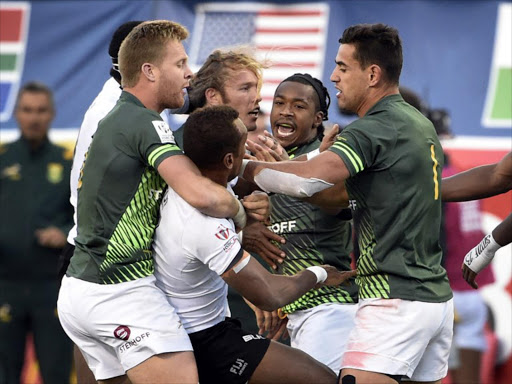 South African (in green) and Fiji players (in white) scuffle on the pitch after an illegal tackle by Sevuloni Mocenacagi of Fiji during day three of the USA Sevens Rugby tournament, part of the World Rugby Sevens Series, March 5, 2017 in Las Vegas, Nevada. South Africa won 19-12.