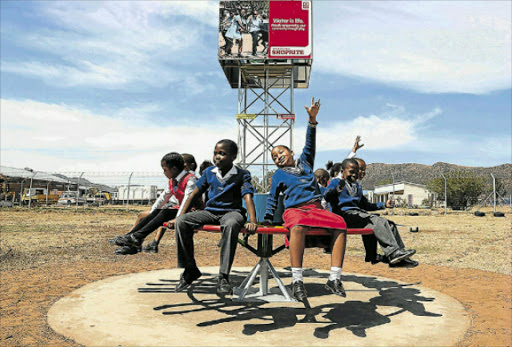 AT PLAY: School children on one the PlayPumps, a merry-go-round which uses the play of children to pump water into a reservoir. Picture: SUPPLIED