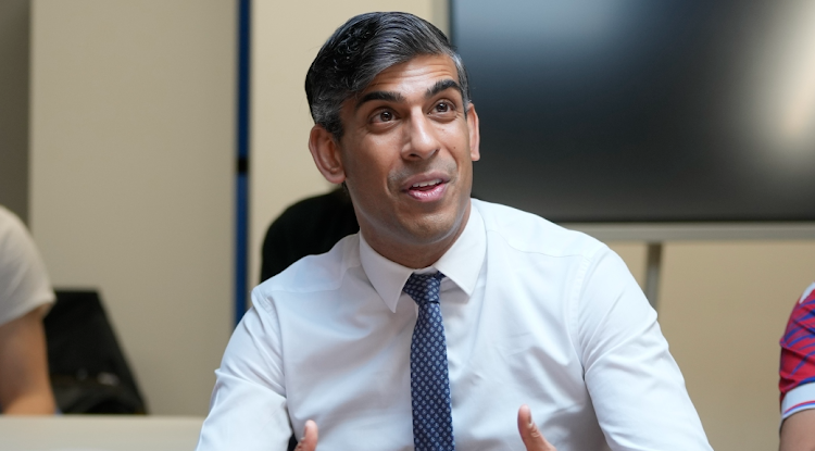 Britain's Prime Minister, Rishi Sunak, gestures as he speaks to people attending a nonprofit organisation during his visit in London on May 7. Picture: AP PHOTO/KIN CHEUNG