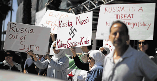 STRIKES CONDEMNED: Syrian-Americans protest against Russian intervention in Syria outside a Russian consular office in Santa Monica, California, United States.Russia moved on Tuesday to resume military talks with the US aimed at setting rules for air-to-air conduct over Syria, a US official said, as the former Cold War foes carry out parallel, uncoordinated campaigns of air-strikes Picture: REUTERS