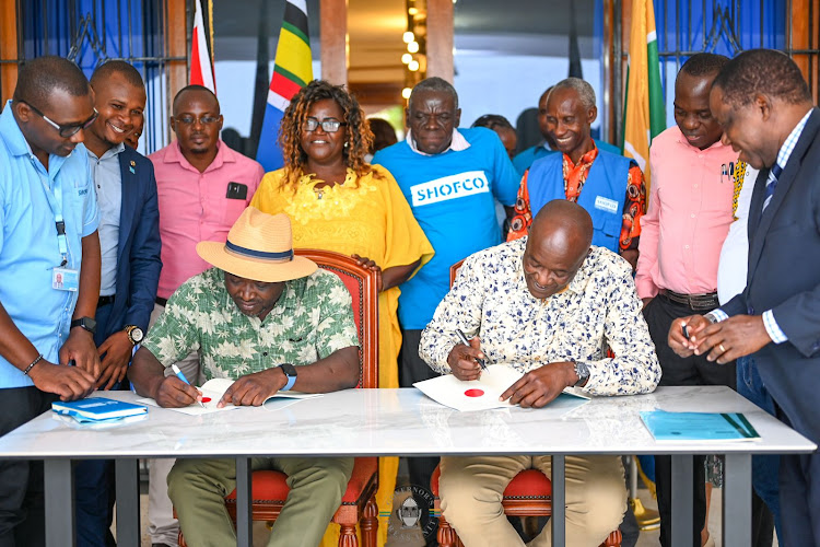 SHOFCO Founder and CEO Dr. Kennedy Odede and Kilifi Governor Gideon Mung'aro sign the MoU.