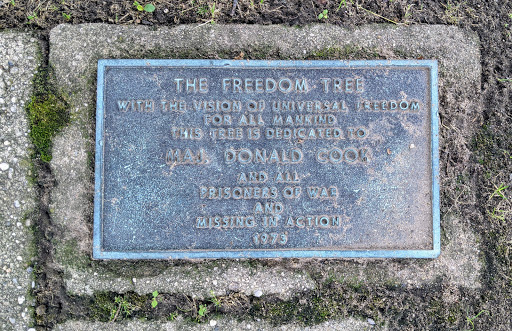 THE FREEDOM TREE WITH THE VISION OF UNIVERSAL FREEDOM FOR ALL MANKIND THIS TREE IS DEDICATED TO MAJ. DONALD COOK AND ALL PRISONERS OF WAR AND MISSING IN ACTION 1973