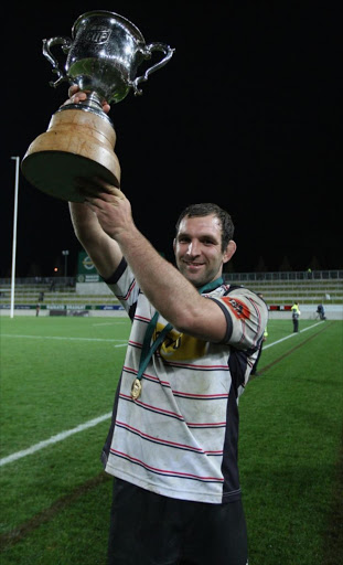 Canterbury captain George Whitelock holds the trophy after winning the ITM Premiership Final between Waikato and Canterbury at Waikato Stadium on September 3, 2011 in Hamilton, New Zealand