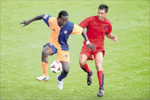 DUEL: Chikondi Likwemba of FC AK shields the ball from Cosmos's Larry Cohen in a recent league match