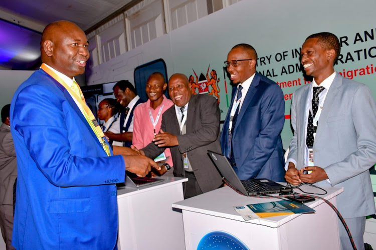 Immigration and Citizen Services PS Julius Bitok shares a light moment with delegates at the NADPA Conference at the Windsor Golf Hotel and Country Club, Nairobi