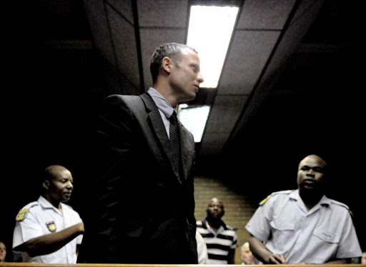 Oscar Pistorius leaves the court room after his hearing on charge of murdering his model girlfriend Reeva Steenkamp. File photo.