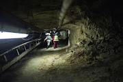 Two women miners walk through a tunnel at the end of their shift at the Anglo American Bathopele Mine in Rustenburg. File photo.